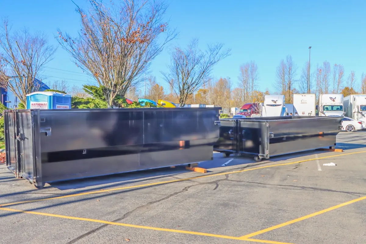 Professional dumpster rental service with roll-off container on residential driveway in Magnolia